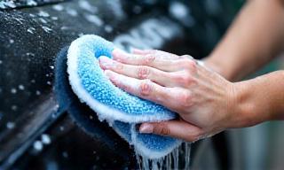 Shudh Shakti technician washing car exterior