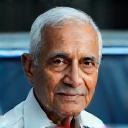 Elderly client Raghavendra Gowda beside clean car